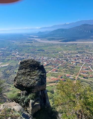 A scenic view from a high vantage point overlooking a town and valley.