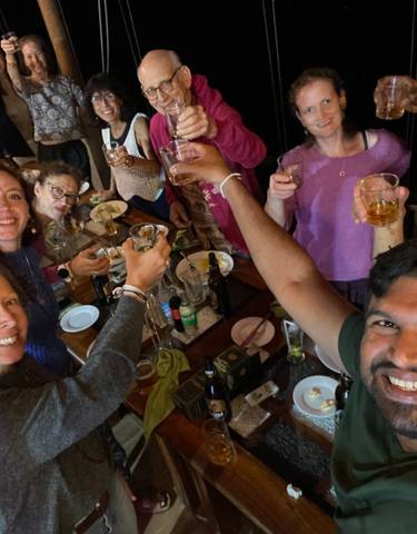 Group of people raising glasses in celebration.