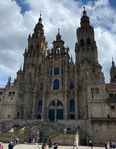 Ornate cathedral with baroque architecture under a partly cloudy sky.