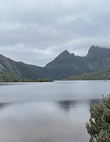 Tranquil lake with mountain backdrop.