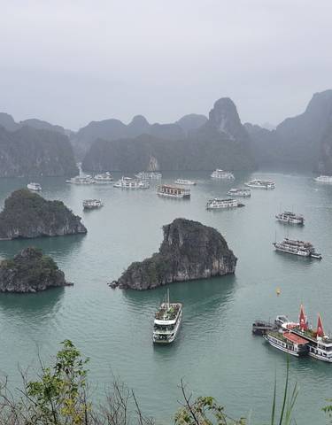 Aerial view of boats in Halong Bay surrounded by limestone islands.