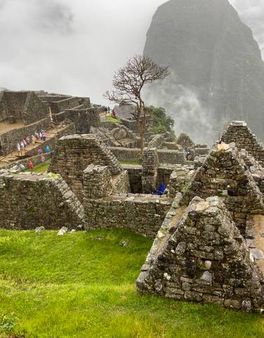 Ancient ruins at Machu Picchu surrounded by mist.