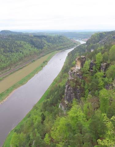 River valley with forested hills and a scenic viewpoint.