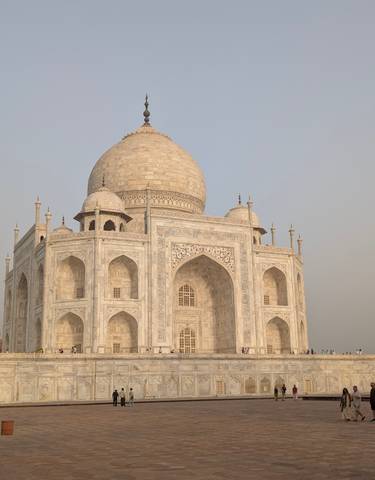 Taj Mahal with early morning light and visitors.