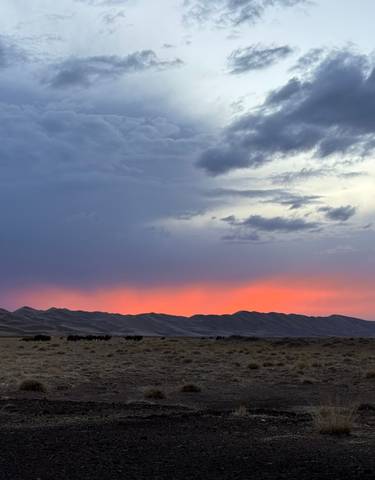 Cloudy sunset over a vast steppe.