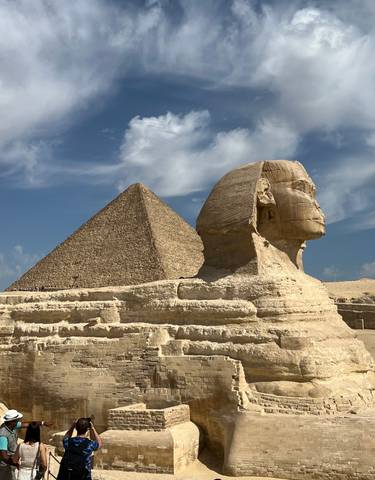 Sphinx and pyramid under a clear sky.