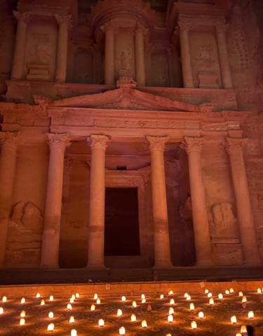 Famous archaeological site with illuminated stone facade.