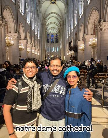Family poses inside a grand cathedral with gothic architecture.