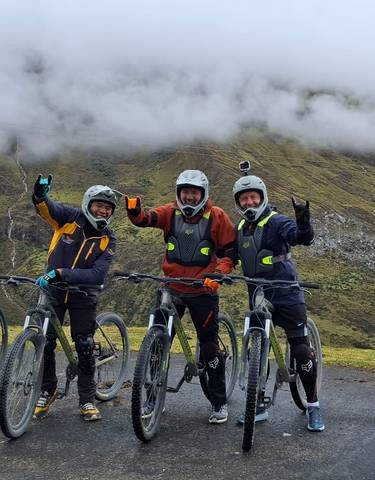 Three people on mountain bikes posing for a photo.