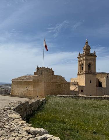 Historic building with a flag on a clear day