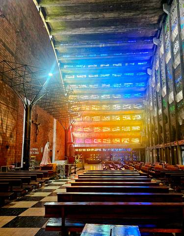 Colorful stained glass windows inside a brick church.