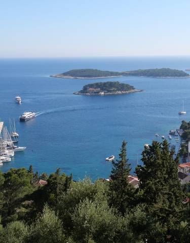 Scenic view of Hvar Island with a port and blue waters.