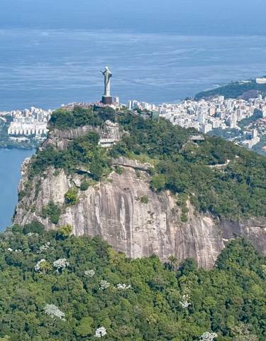 Aerial view of Christ the Redeemer statue overlooking the city and coastline.