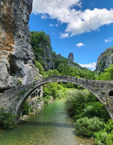Beautiful stone bridge surrounded by a rugged landscape.