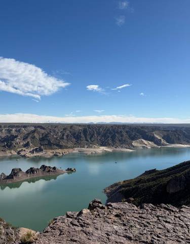 Scenic view of a tranquil lake and the surrounding mountains.