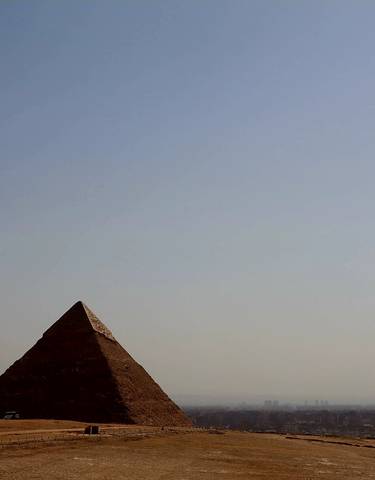 Three pyramids under a clear sky.