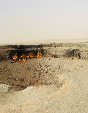 A large fiery crater in a barren landscape.