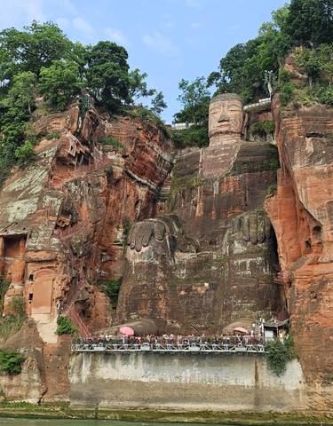 Leshan Giant Buddha carved into rock face.
