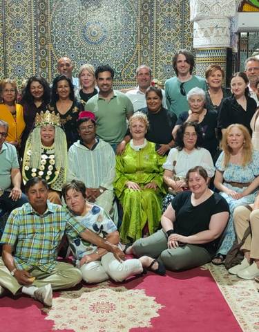 Group gathered in a beautifully tiled room, smiling for the camera.