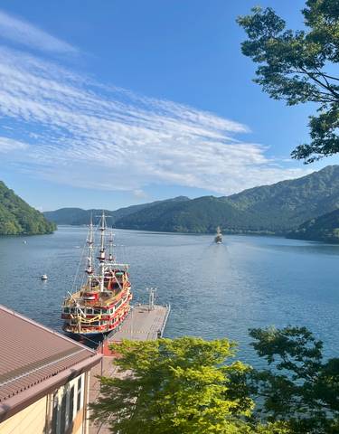 Scenic view of a lake with mountains and a ship.