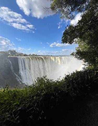 A majestic view of a large waterfall with a rainbow.