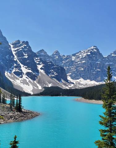 Stunning turquoise alpine lake surrounded by snow-capped mountains.