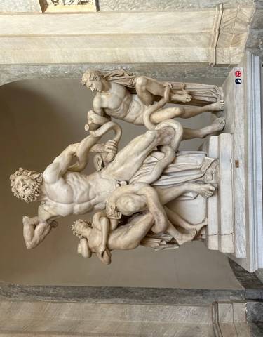 Ancient marble statue in a museum setting.