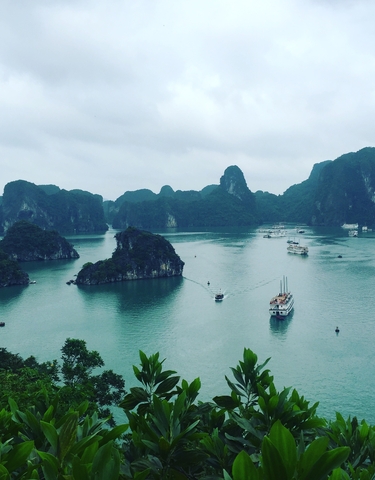 Scenic view of Halong Bay with boats and limestone islands.