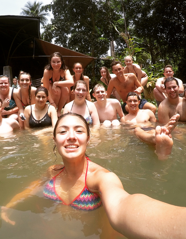 Group of people relaxing in a natural pool.