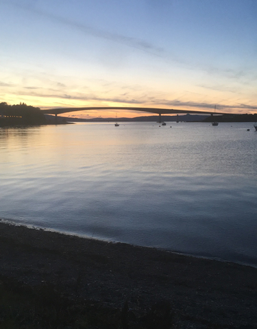 Bridge across a body of water at sunset.