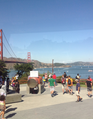 Crowded area with the Golden Gate Bridge in the background.