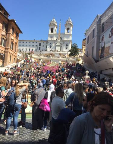 Crowded Spanish Steps with flowers in Rome.