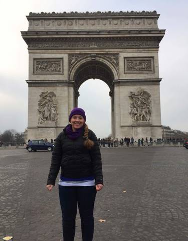 Person standing in front of the Arc de Triomphe.