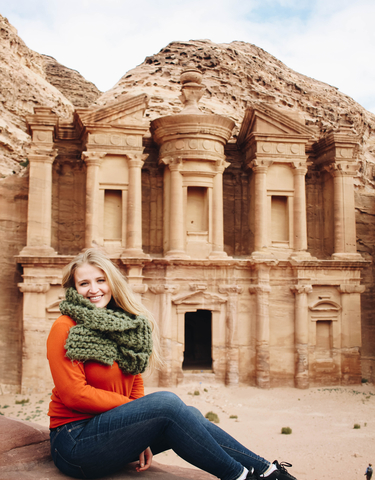 Woman posing in front of a historical monument.