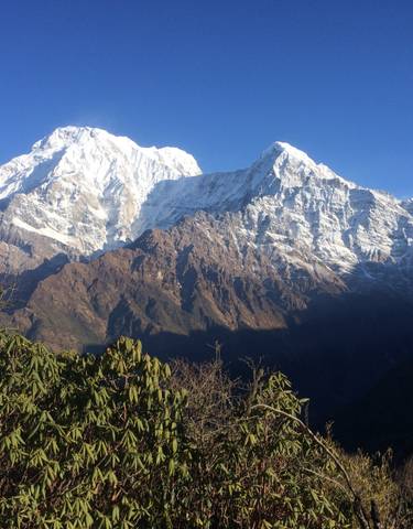 Majestic snow-capped mountains with clear blue sky.