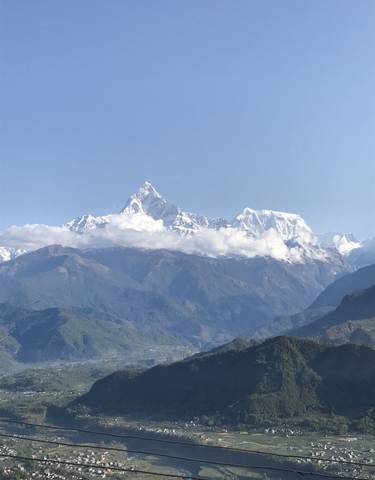 A majestic view of snow-capped mountains under a clear sky.