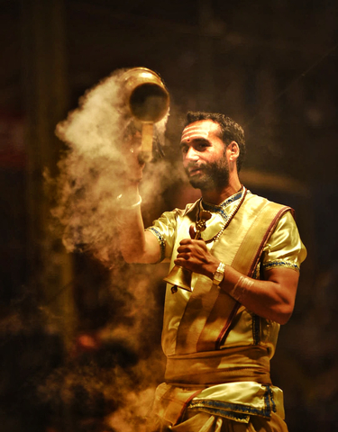 Man performing a religious ceremony with incense.
