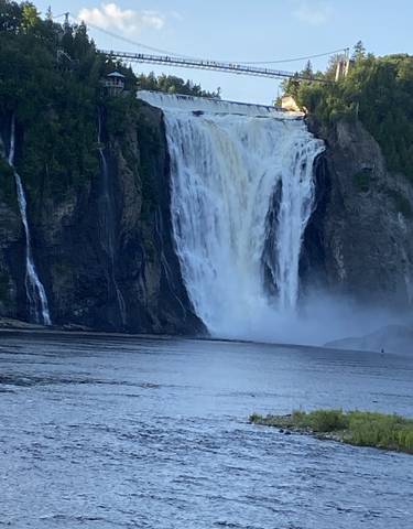 Large waterfall with a bridge above.