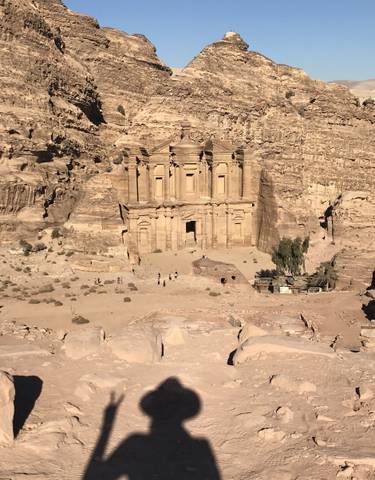 Distant view of Petra's Monastery with surrounding rocks.