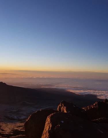 A stunning mountain view during a sunrise with rock formations.