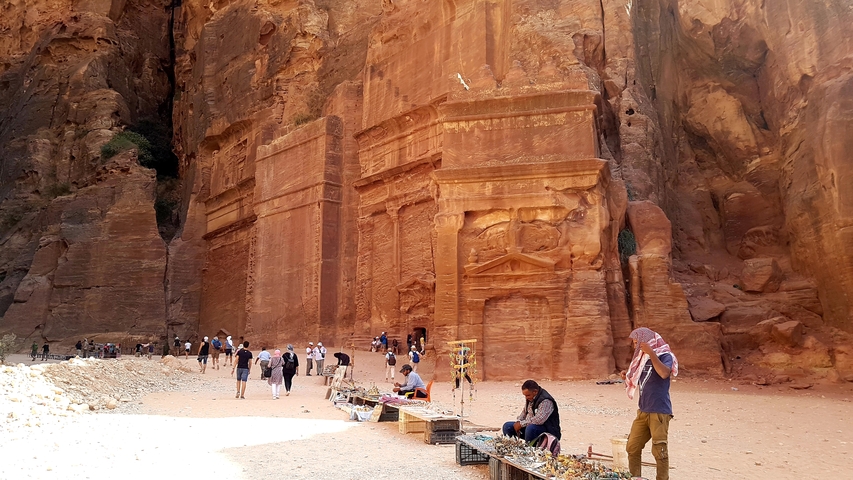 Visitors exploring historic rock-carved remains.