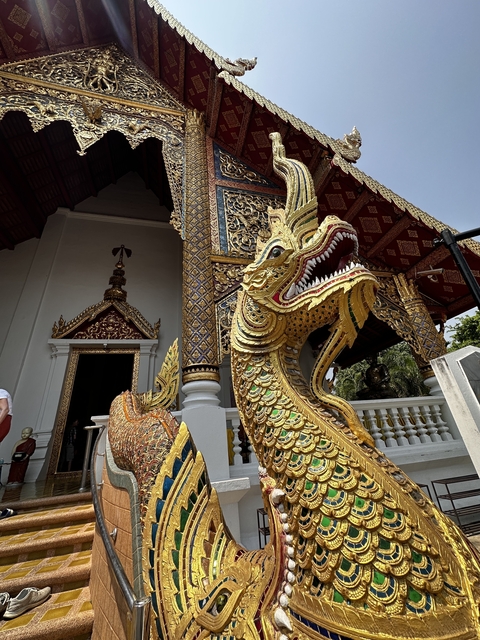 Ornate dragon statue at the entrance of a temple.