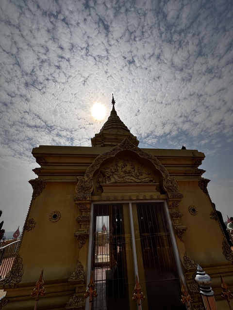 Temple with detailed carvings against a bright sky.