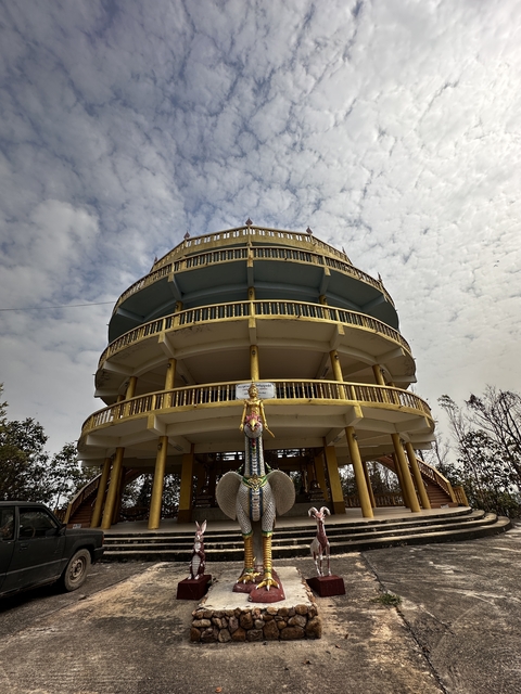 Large circular temple structure with gold accents.
