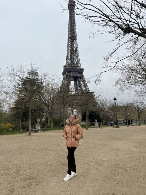 Person standing near the Eiffel Tower.