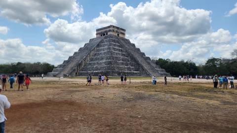 Tourists visiting Chichen Itza pyramid.