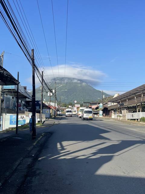 Street view with a mountain in the background.