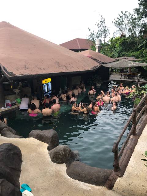 People enjoying a pool or hot spring experience.