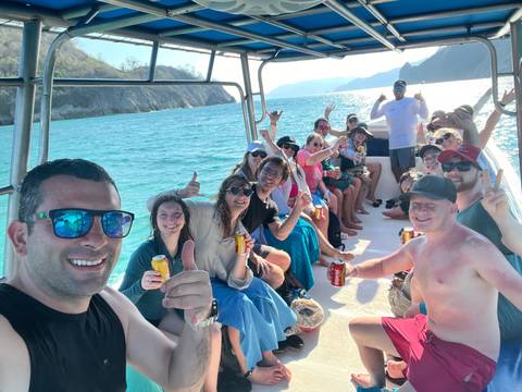 A group of people enjoying a boat ride on the water.