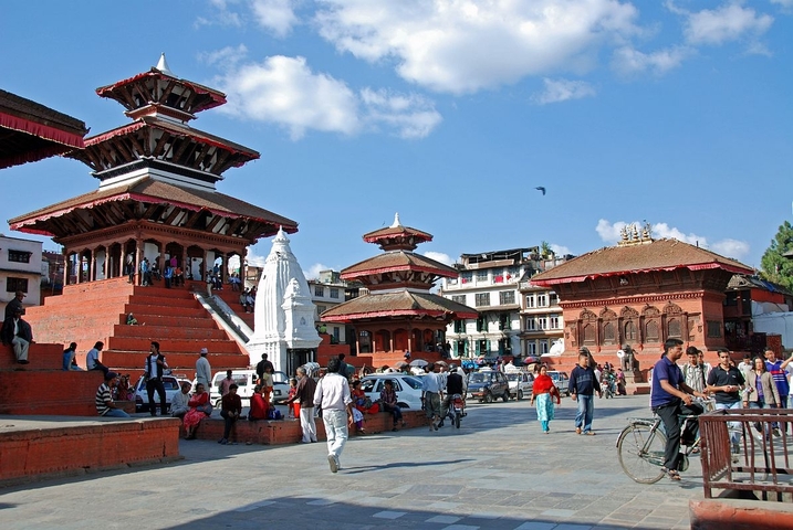 Busy public square with traditional buildings.